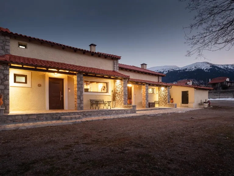 Chalet Renata 2 exterior at dusk with the Parnassos mountain range in the background.