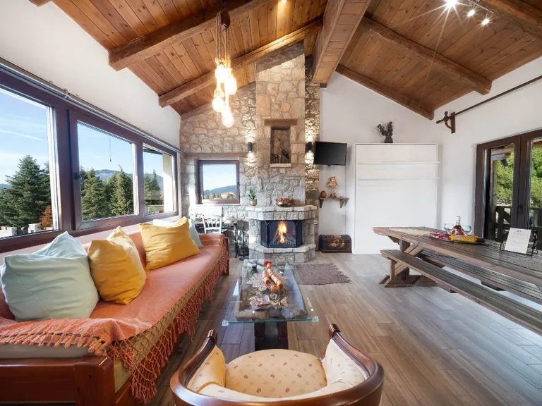 Villa Dianne 2 living room with stone fireplace, comfortable seating and mountain views.