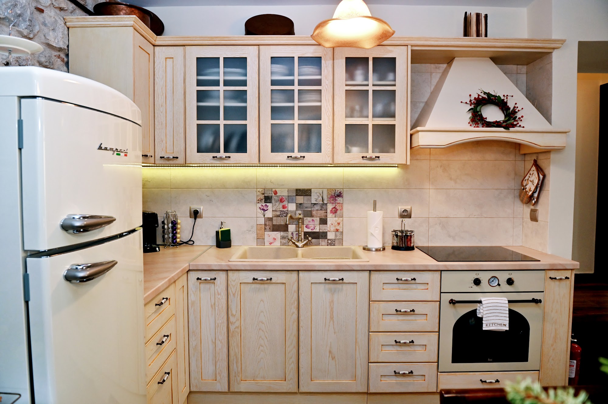 Traditional-style kitchen with white cupboards and oven.