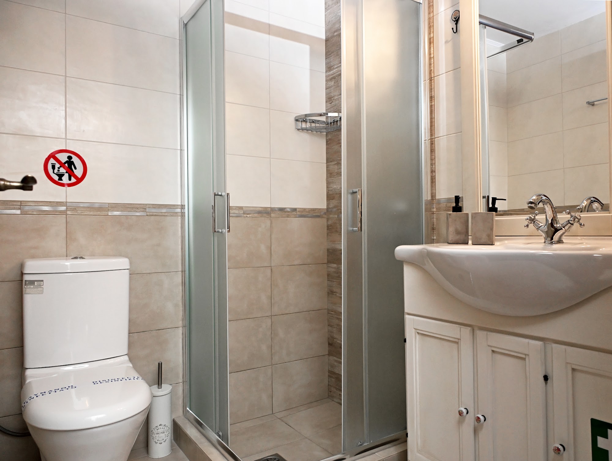Bathroom with a shower enclosure, sink and toilet.