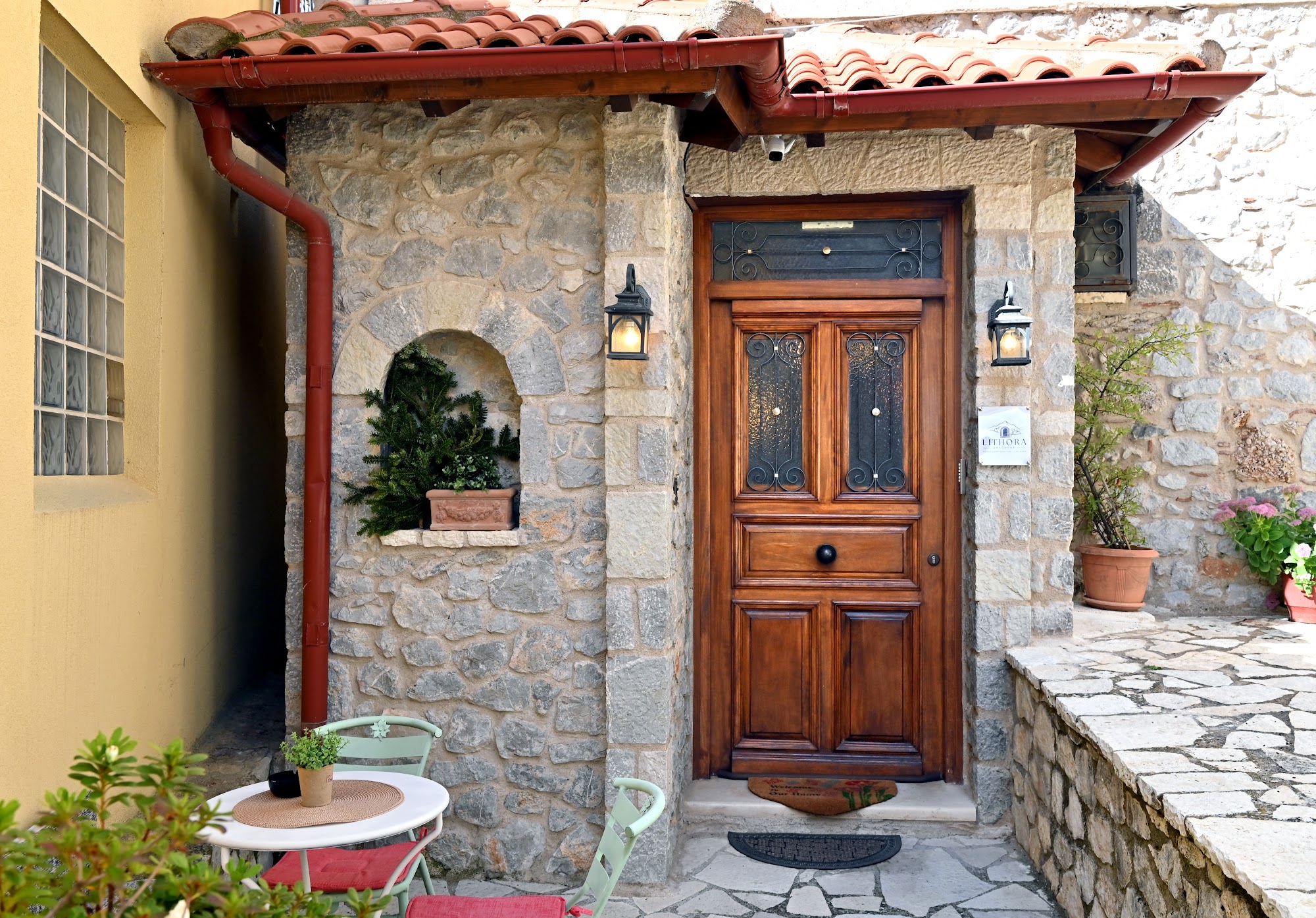 Wooden front door set into a stone entrance.